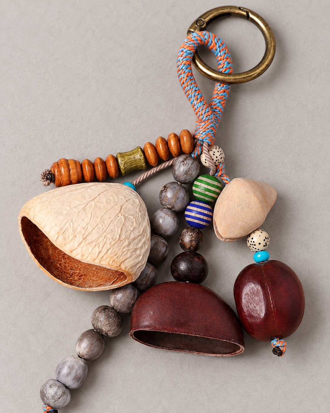 Close-up of Tumble's cream, tan, and reddish-brown botanical shell forms with layered natural decorations
