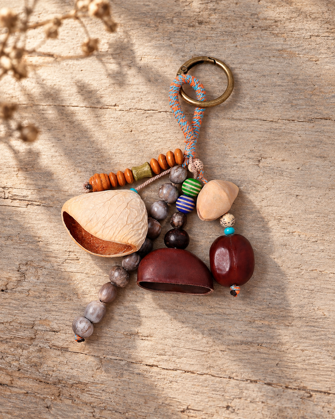 Tumble handmade bag charm photographed on aged wood with soft botanical shadows